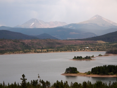 [Shadowy mountains rise in the distance behind Lake Dillon.]