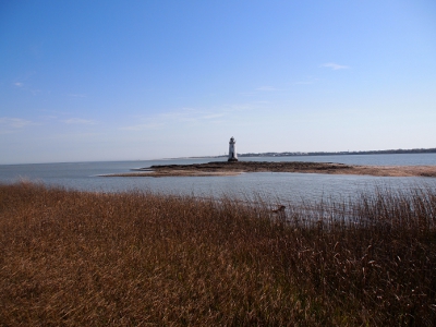 [View of lighthouse on small island away from main island.]