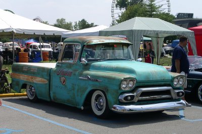 [Light green truck with Indian motorcycles and a phone number painted on side. This vehicle has not been restored.]