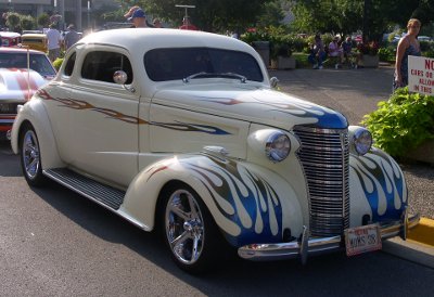 [Creme colored car with dark blue flames.]