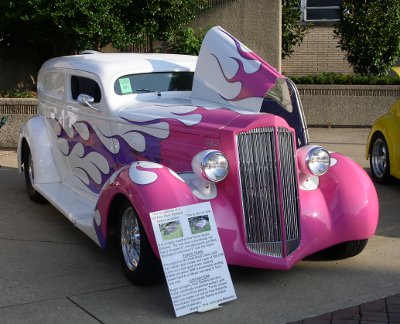 [White car with pink purple flames.]