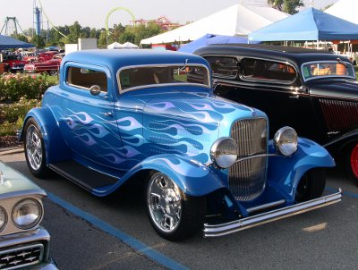 [Blue car with light blue flames along hood and sides.]