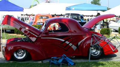 [Red car with black and white vees along the side.]