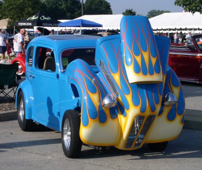 [Blue car with cream/yellow colored flames.]