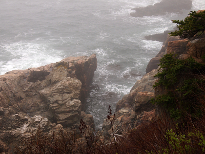 [Lots of wave and water action near the shoreline rocks.]