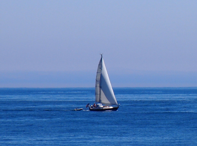 [Large sailboat in the beautiful blue water. Not a cloud in the sky.]