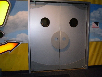 [Two doors for which handles look like a pig snout and windows look like eyes.]