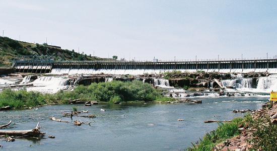 [View of the falls from the ground just below the falls and thus looking straight at the waterfalls created by the rock.]