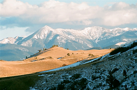 [Closeup of mountains - some with snow and some just light brown.]