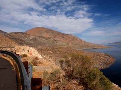 [More of the ground leading up to the water. Guardrail can be seen in lower left of image.]