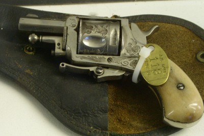 [Small pistol with flowery designs engraved in the barrel and surrounding metal.]