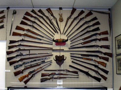 [Large display of rifles mounted in a circle on the wall.]