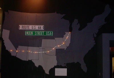 [Map of the US with Route 66 shown by a moving light stream.]