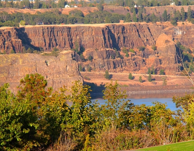 [Several rows of scored rock forming cliffsides along the river.]