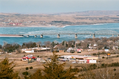 [Bridge across part of river. Land arm carries rest of bridge.]