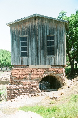 [Wooden structure atop a brick base which is based on blocks of Sioux quartzite. This sits on one side of the river.]