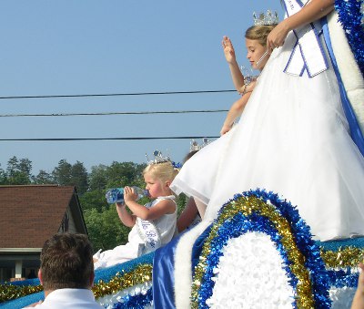 [Little princess girl on float drinking a bottle of water.]