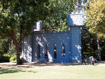 [Side view of this structure made to look as if it was built of stone blocks. Structure is at least 20 feet high and has long, narrow, slit openings in the wall.]