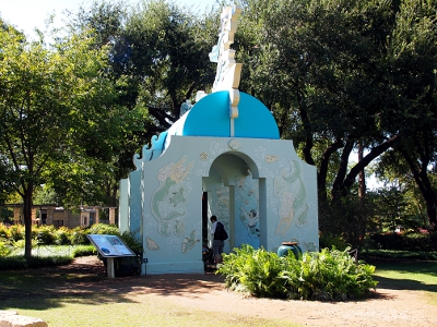 [Front of a white and blue castle with a curvy top resembling waves. The side is painted with sea creatures.]