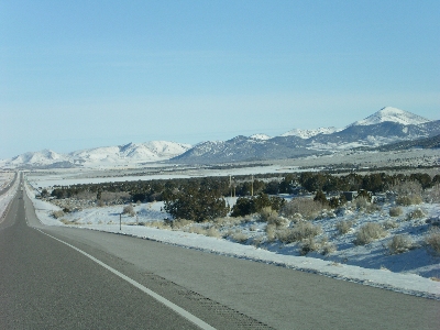 [Long highway view with mountains in distance.]