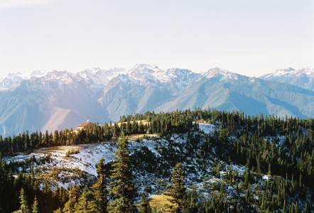 [A view of snow amid the near mountain top and numerous snow-capped mountains in the distance.]